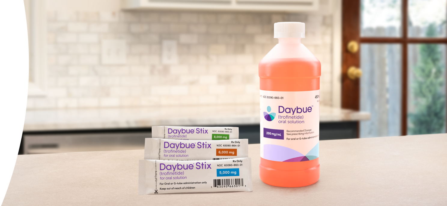 DAYBUE® (trofinetide) ready-to-take liquid next to DAYBUE® STIX (trofinetide) individual packets.
