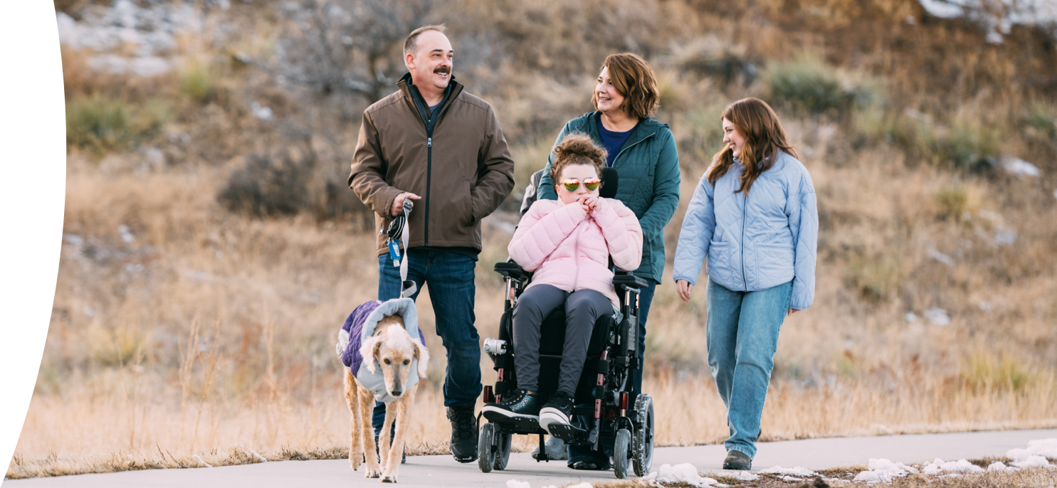 Maddy, age 20, living with Rett syndrome, with her family