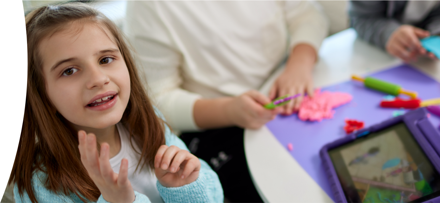 Kate, age 9, living with Rett syndrome, playing with a tablet and doing crafts with her mom
