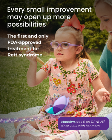 Madelyn, age 5, living with Rett syndrome, holding an ice cream cone. The light makes a circle around Madelyn.
